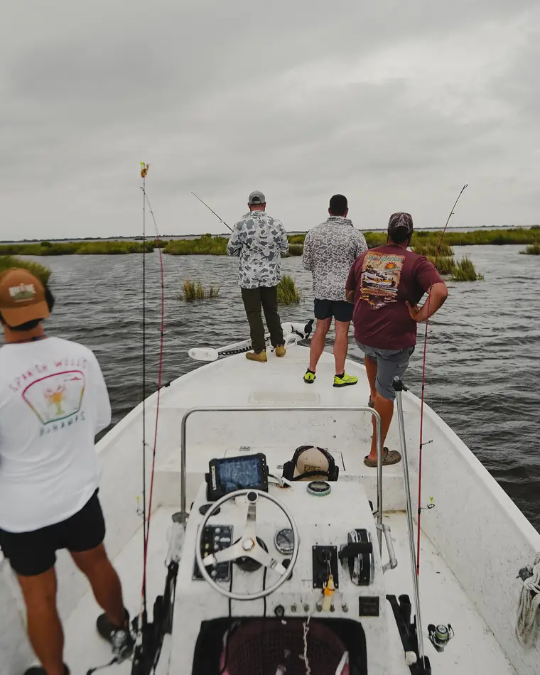 Anglers fishing the marsh from a bay boat